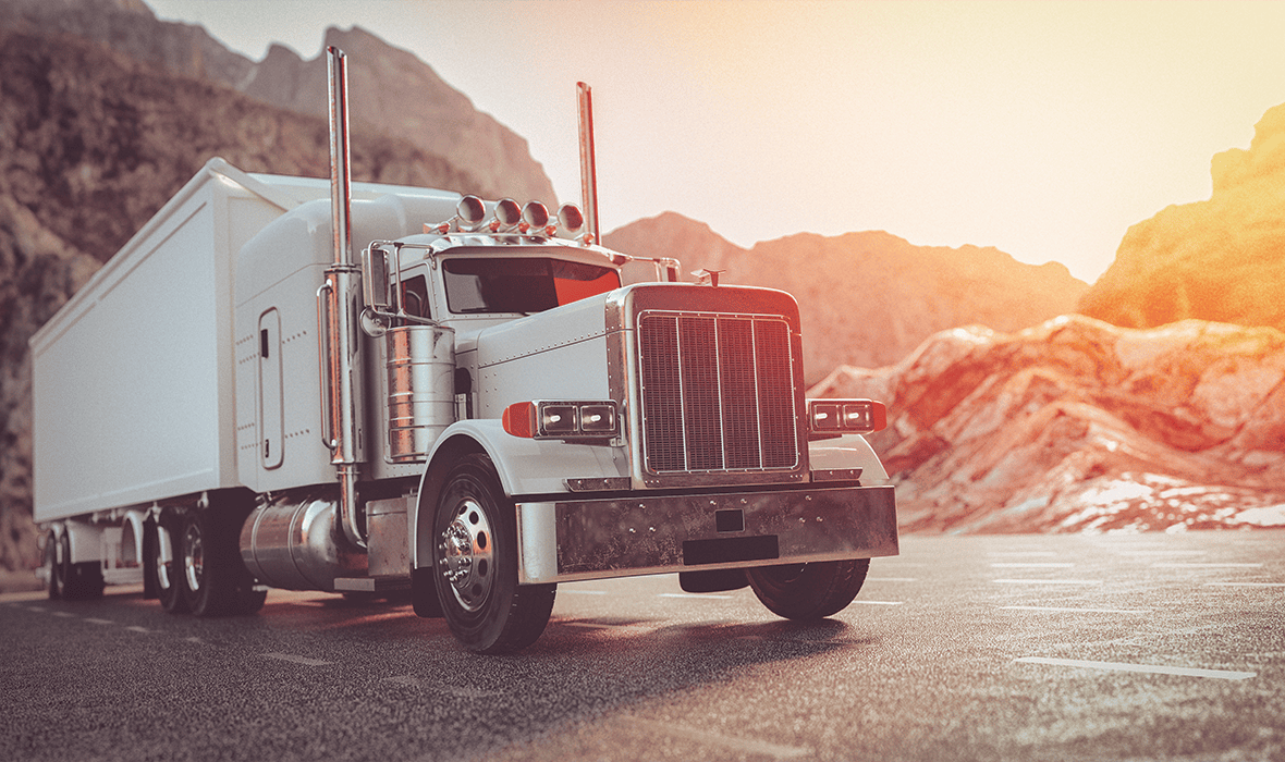 A white truck running on the street in the morning.