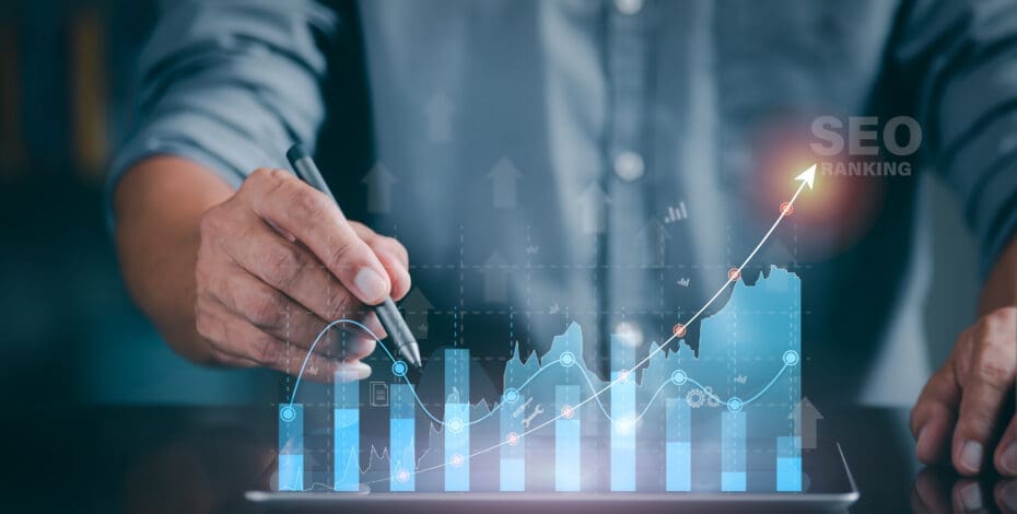A man holds a pen while pointing at a digital bar graph. There is a red arrow running upward through the bar graph. The phrase 'SEO rankings' is next to the red arrow.