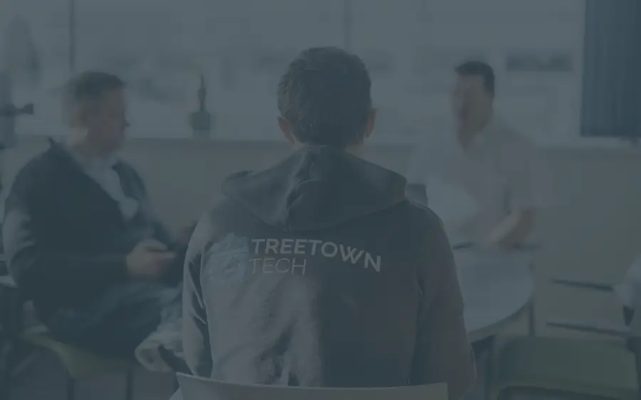 A group of Treetown Tech employees meeting to discuss a project.