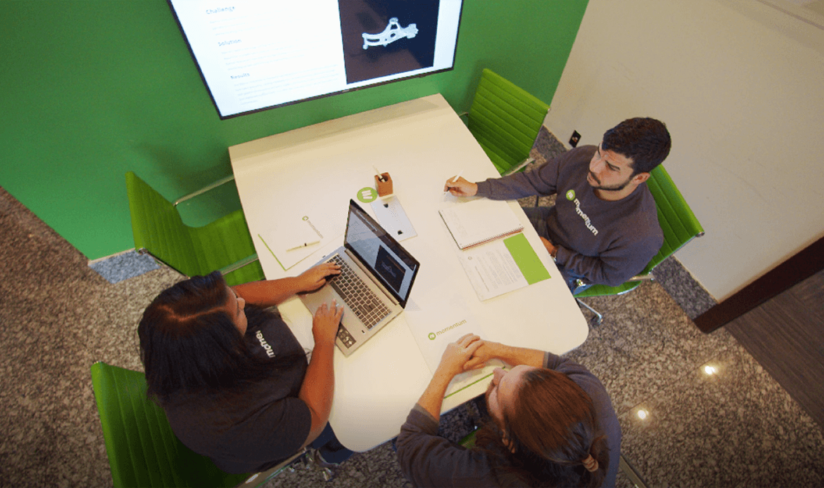 Overhead view of Momentum team discussing strategies
