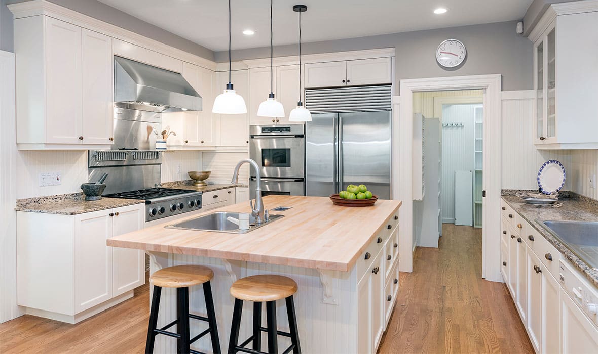 Amazing Luxury Kitchen Interior in white with wooden floor and kitchen island.